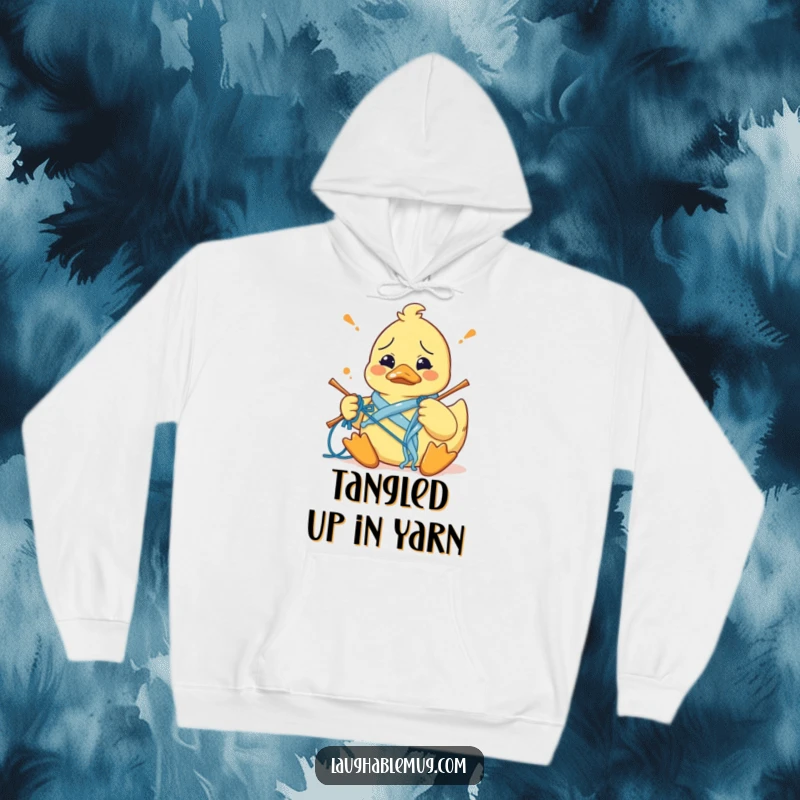 Funny hoodie featuring a confused rubber duck comically tangled in knitting yarn, attempting a craft with bewildered expression.