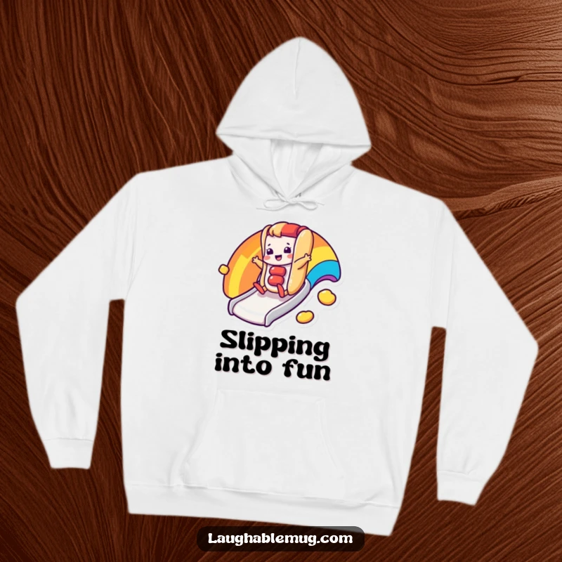 Funny hoodie with a happy hot dog character sliding down a rainbow slide, perfect for cozy fun.