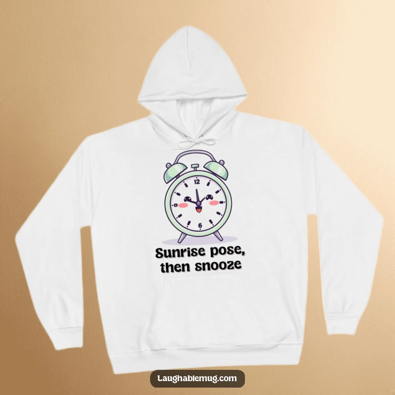 Funny hoodie depicting a beaming alarm clock in a yoga pose, offering comfort and a dose of humor.