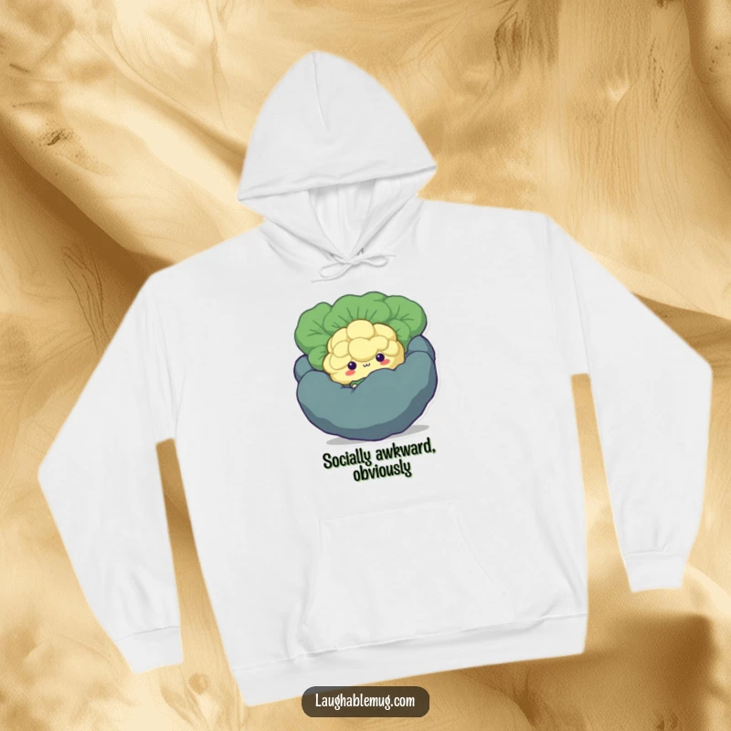 Funny Shy Broccoli Hoodie: A warm and cozy hoodie featuring a bashful broccoli floret character peeking out from behind a larger vegetable.