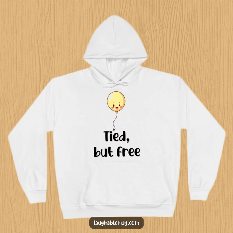 Funny hoodie depicting a playful balloon juggling its string in an attempt to escape, offering cozy whimsy.