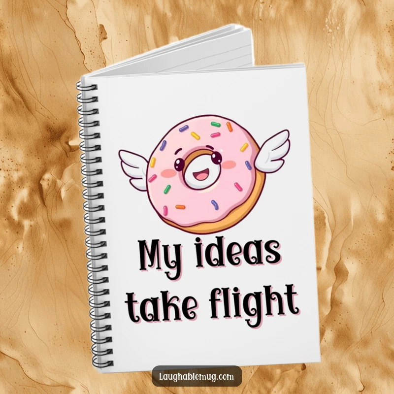 Funny notebook cover with a cheerful donut and tiny wings, attempting flight, embellished with colorful sprinkles.