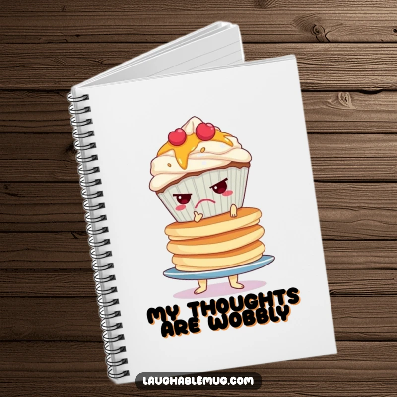 Funny notebook cover with a grumpy cupcake precariously balancing a wobbly stack of pancakes, inspiring relatable note-taking.