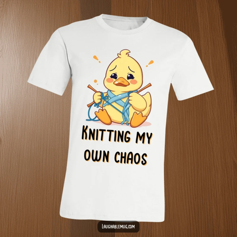 Funny t-shirt depicting a bewildered rubber duck hilariously struggling to knit, entangled in yarn, embodying craft fail humor.