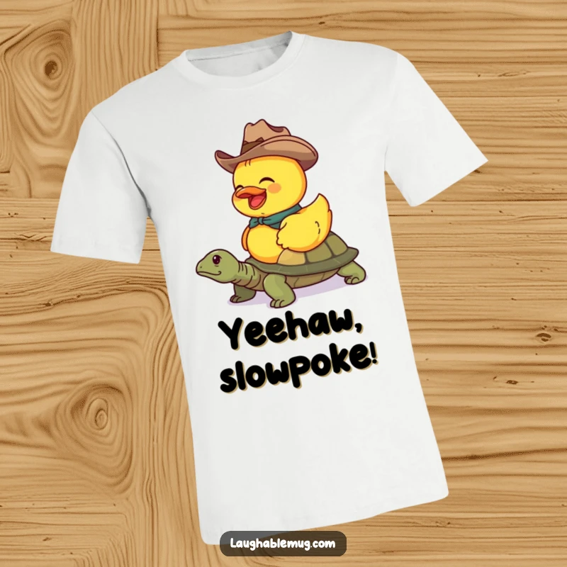 Funny T-shirt with a giggling rubber duck in a cowboy hat, humorously riding a turtle, perfect for unique style.