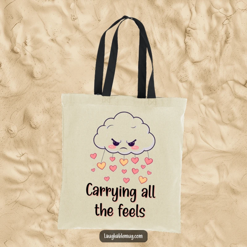 Funny tote bag showing a grumpy cloud shedding happy heart-shaped rain, a unique accessory.