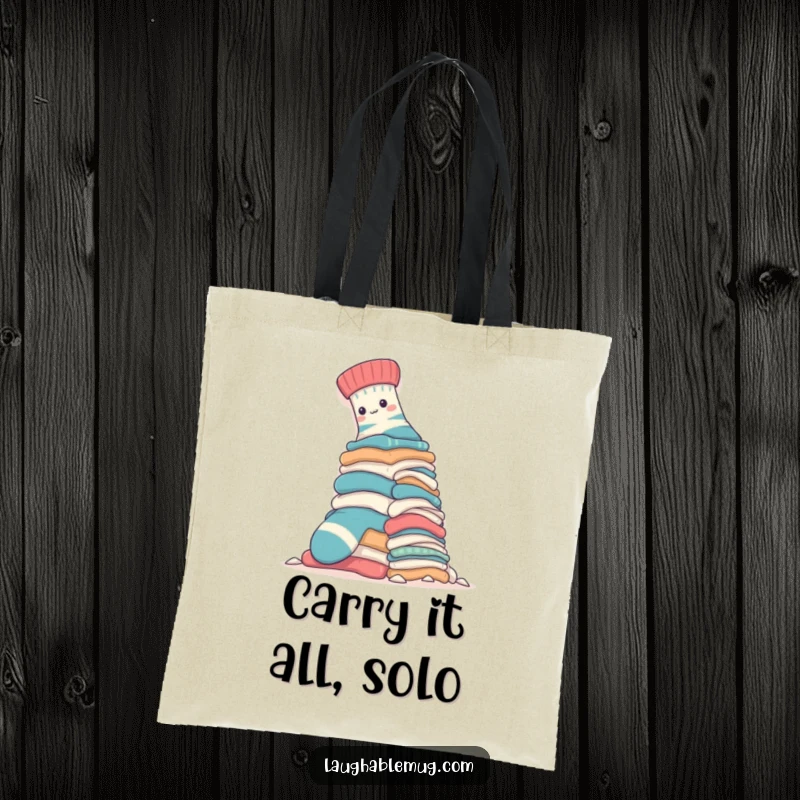 Funny Tote Bag: A brave sock ascends a towering laundry pile, illustrating a courageous effort in a humorous, relatable fashion for shoppers.