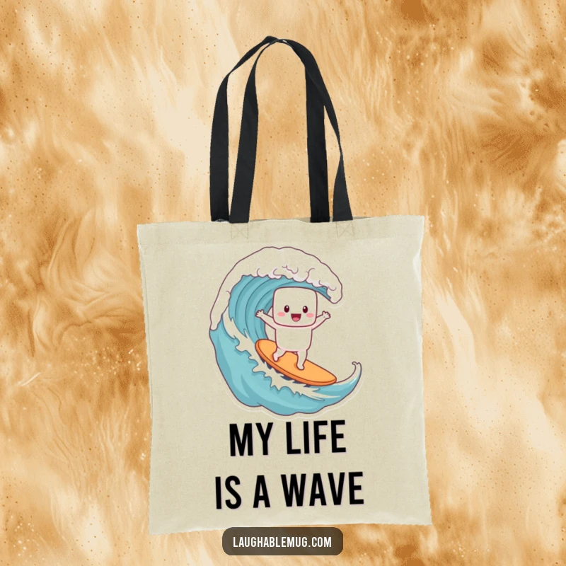 Funny tote bag featuring a joyful marshmallow character surfing a massive coffee wave, designed for carrying everyday items with style.